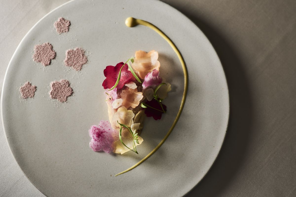 信州の佐久で育った佐久鯉に、野菜でつくった繊細な花びらと塩で桜を散らした華やかなひと皿