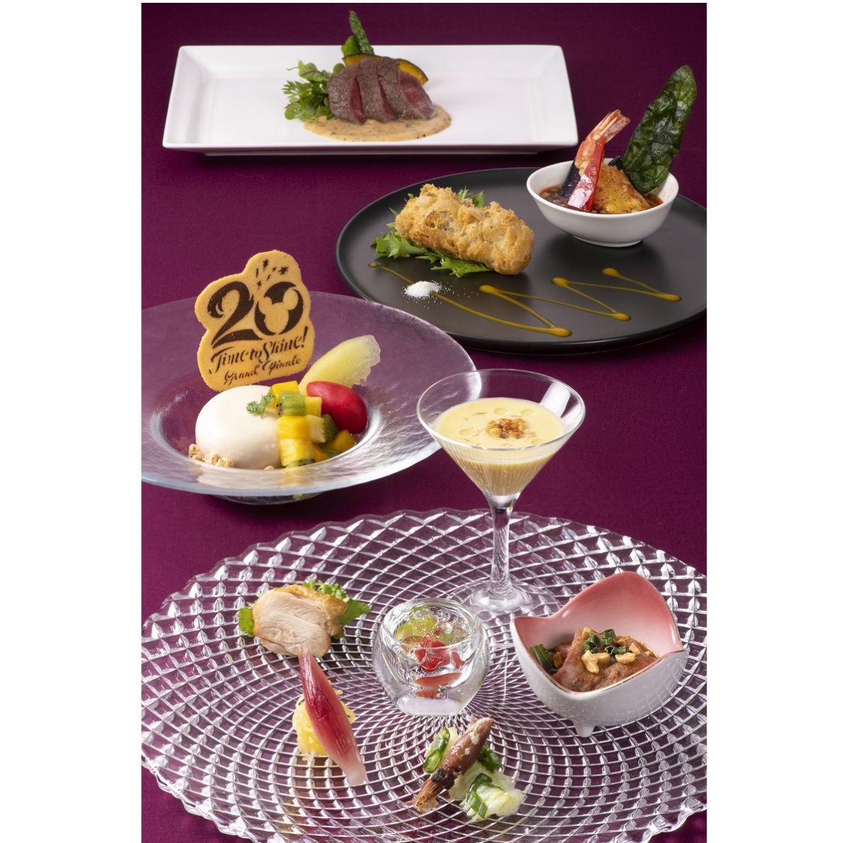 「東京ディズニーシー20 周年：タイム・トゥ・ シャイン！」グランドフィナーレ「ディナーコース」 ■前菜の盛り合わせ ■冬瓜と枝豆の茶碗蒸し風スープ キャヴィア添え ■鶏肉とモッツァレッラのライスペーパー包み揚げ 海老の唐揚げ 油淋ソース ■牛フィレ肉のソテー 黒胡椒ソースとともに ■帆立貝と野菜の梅風味焼きそば ■ライチー紅茶のムース ラズベリーソルベ添え、または今月の特製杏仁豆腐（+500円）