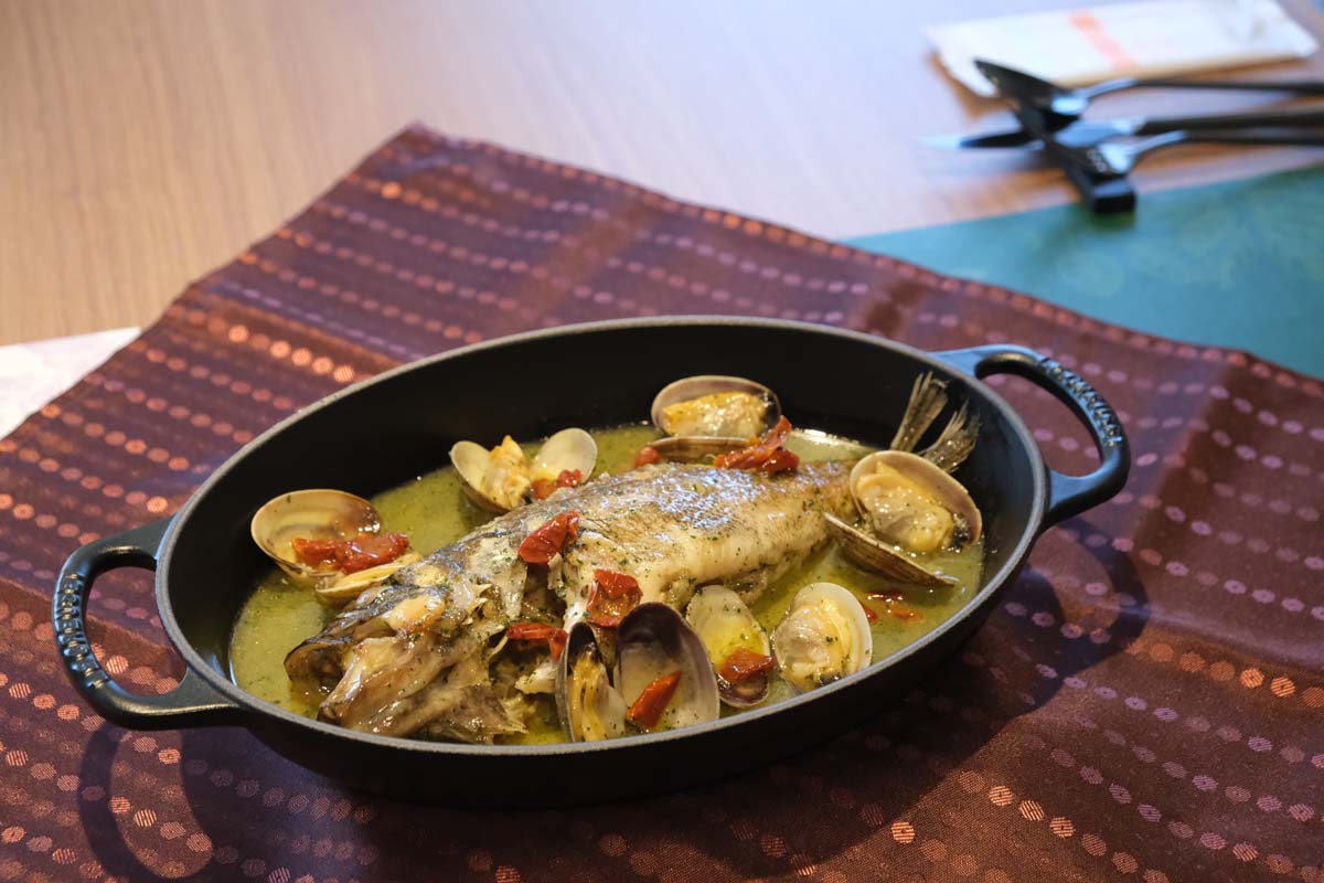 日髙シェフのスペシャリテ「アクアパッツァ」。ランチコースでは切り分けて提供される