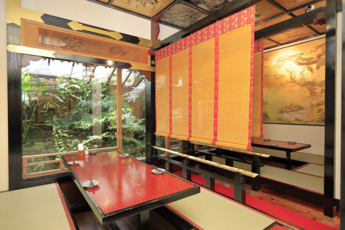 中国風の座敷席からは亜熱帯の植物が茂る庭を一望
