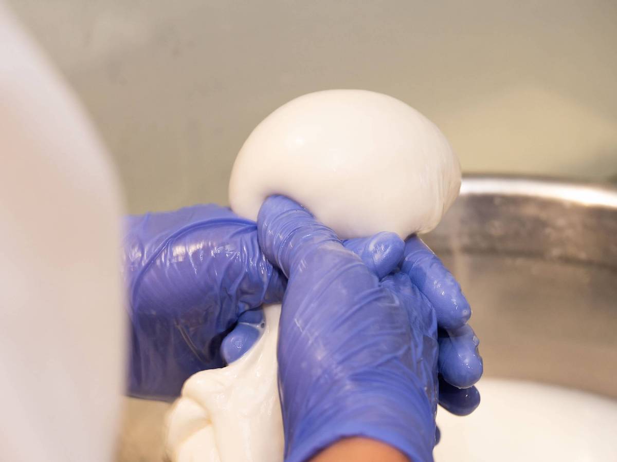 こちらは90度のお湯の中で「ブッラータ」の包み作業中！ 