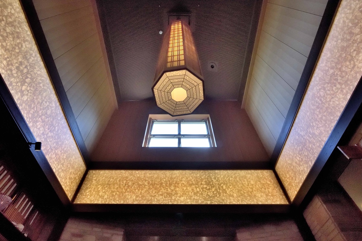 陰陽吉祥文様の和紙越しにやわらかな照明が注ぐエントランスホール