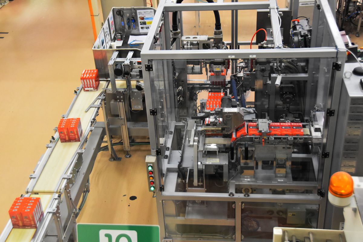 さまざまな検査のあとに【9】箱詰め機で8箱ずつのかたまりとなって流れていきます