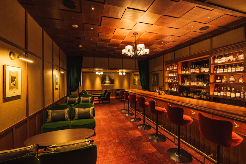 赤い椅子のカウンターとグリーンのソファ席がシック