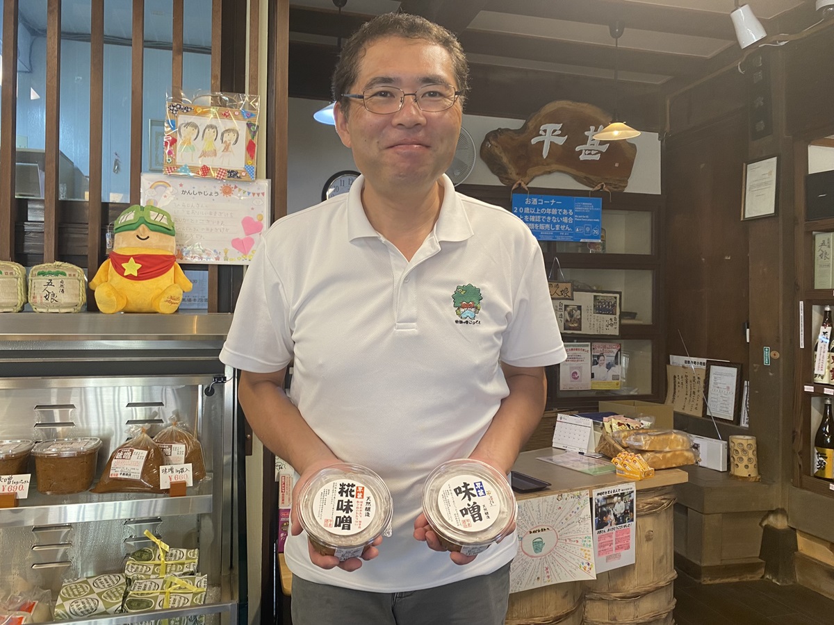 現当主の平野秀昭（ひらのひであき）さん。「平甚味噌」500g400円と糀多めの「糀味噌」500ｇ420円