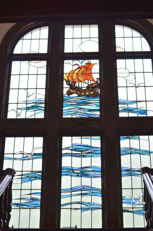 海を渡る帆船が描かれた階段踊り場のステンドグラス