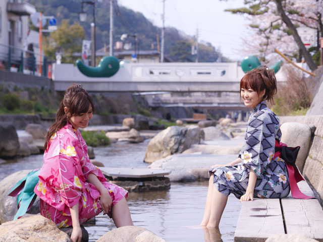 玉湯川沿いの足湯。奥に見えるのは緑の勾玉が埋め込まれた勾玉橋